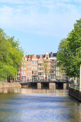 Amsterdam, Netherlands - June 30, 2019: The historic city center of Amsterdam in the morning. Street (channel) Singel