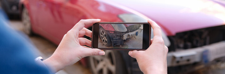 Woman insurance broker making photo of car after accident on smartphone