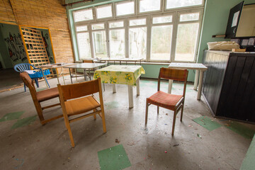 Old, dilapidated tables and coffee tables in an abandoned building. Urbex.