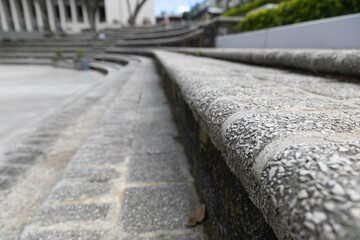 Seating steps in a city square that are laid out in a wide arc and invite you to rest and sit