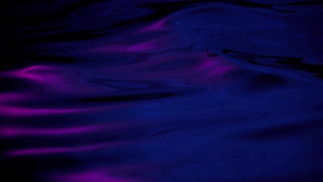 Elegant abstract close-up macro water wave loop background. Purple blue copy space showcase mock-up element backdrop. 3D animation of fluid molten shape of liquid shiny indigo ultraviolet oil surface.