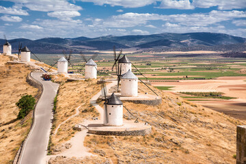 Series of windmill of Consuegra on the hill and in the background the plain of La Mancha (Spain)