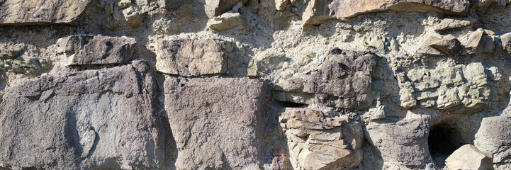 Old stone wall background, dark rock surface