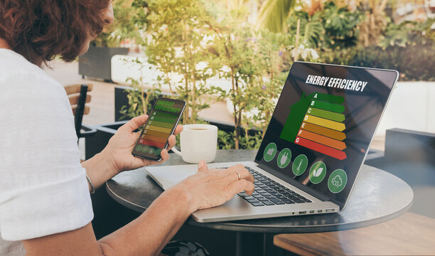 Woman calculating energy buildings efficiency class. Ecological and bio energetic house concept.