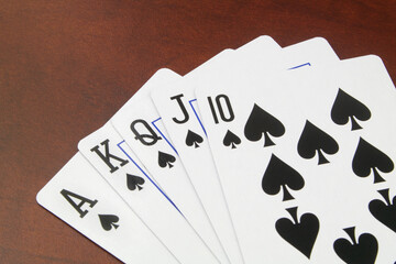 Spades playing cards on wooden table. Gambling concept.