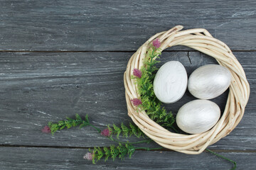 Happy Easter. eggs on wooden table background.. Balls, wreath woven from the vines. Copy space for text. Top view.
