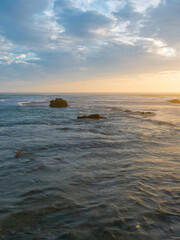 Fototapeta na wymiar Ocean water around the rocky shore in high tide.