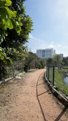 Walking lane of iblur lake with green cover and clear cloudy skyn and cityscape infrastructure.