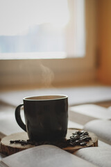 morning coffee, coffee beans and cup on wood and books