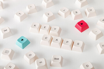 Buttons for a mechanical keyboard, key caps are scattered randomly on a white background. Close-up....