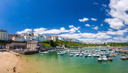 Naklejka na ściany i meble Harbour with colourful buildings (Tenby, Wales, United Kingdom, in summer)