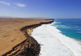 Aerial mid level panoramic view of the rocky cliffs and beaches near El Cotillo in Fuerteventura Spain
