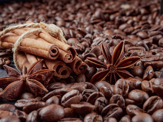 Cup of steaming hot coffee with coffee beans, coffee grinder, and coffee beans bag in background.