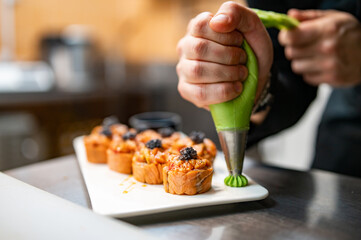 professional chef's hands making sushi and rolls in a restaurant kitchen