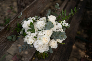 Obraz na płótnie Canvas Wedding bouquet of white flowers - ranunculus, freesia, lisianthus.. Wedding. Bride and groom.