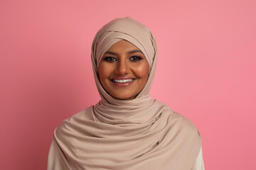 Portrait Of Beautiful Young Muslim Woman In Hijab Posing Over Pink Background