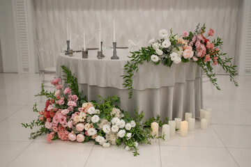 Main table at a wedding reception with beautiful fresh flowers and candles.