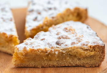 Three pieces of pie in wooden desk on white background
