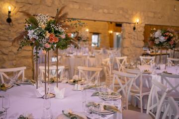 Luxury wedding table setting with flower centerpieces and candles
