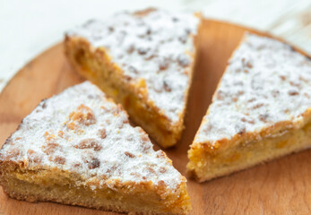 Three pieces of pie in wooden desk on white background