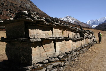 Piedras esculpidas con oraciones budistas, apiladas junto al camino de ascenso en el valle de...