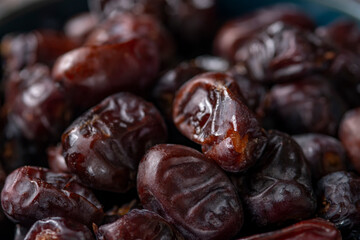 dates and nuts in a bowl on a dark background