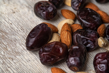 dates and nuts in on a grey wooden background