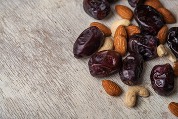 dates and nuts in on a grey wooden background