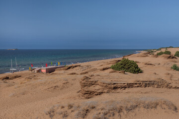 Corfu Island beach, dark yellow sand. A stretch of beach with a blue lagoon.
