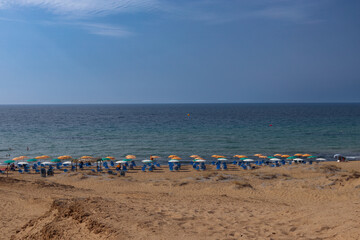 Fototapeta na wymiar Corfu island's sandy beach, umbrellas and chairs.