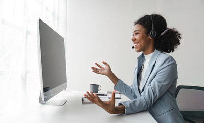 Portrait of happy smiling female customer support phone operator at workplace. Smiling beautiful...