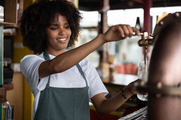 Beautiful African waitress woman serving beer