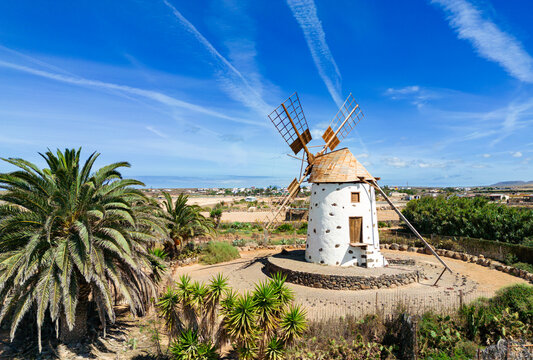 Beautiful low level aerial view of a historic traditional Canarian windmill near El Cotillo in Fuerteventura Spain