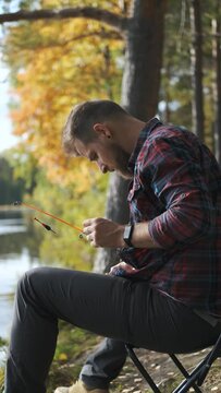 vertical video, a fisherman prepares a fishing rod for fishing