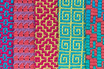 Different mosaic crochet pattern. Abstract knitted background.