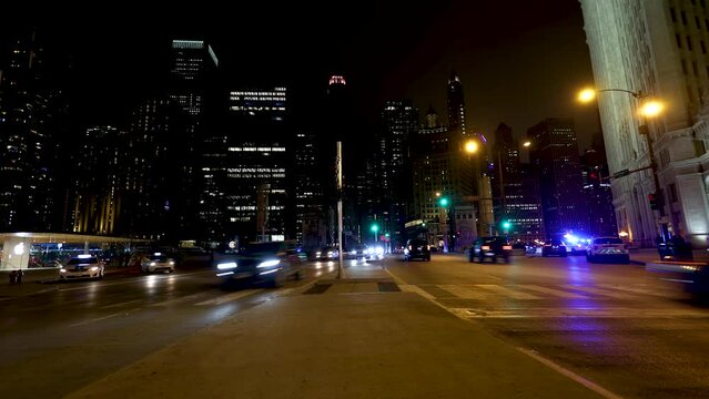 Chicago IL USA February 24th 2023:Night time lapse of Chicago streets downtown. the cars in traffic left trails of lights as they speed by on the expressway in this urban expressway 