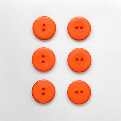 Orange plastic buttons on a white background. Sewing tools.