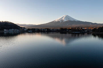 Mount Fuji on a bright winter morning, as seen from across lake Kawaguchi, and the nearby town of Kawaguchiko.