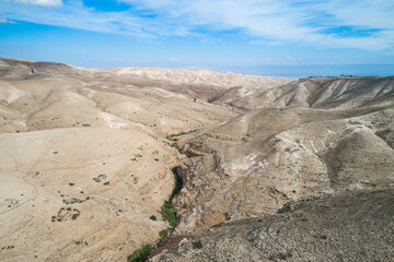 Fototapeta na wymiar Israel. Prat River. Wadi Qelt valley in the West Bank, originating near Jerusalem and running into the Jordan River near Jericho and the Dead Sea. Nahal Prat, in Judaean Desert. Nature, Landscape