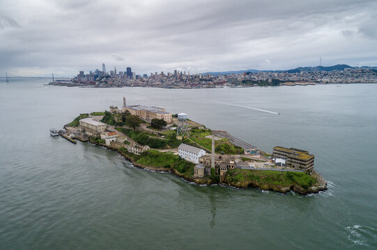 Aerial view of Alcatraz island in the San Francisco Bay. USA. The most famous Alcatraz Prison, Jail. Sightseeing Place. San Francisco Cityscape in Background. Drone