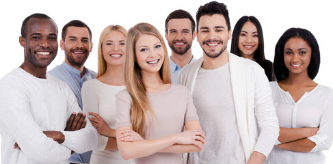 Group of happy young people looking at camera while standing against white background