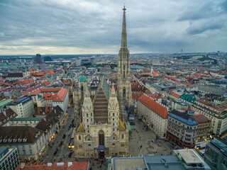 Fototapeta na wymiar St. Stephen's Cathedral in Vienna, Austria. Roof and Cityscape in Background.