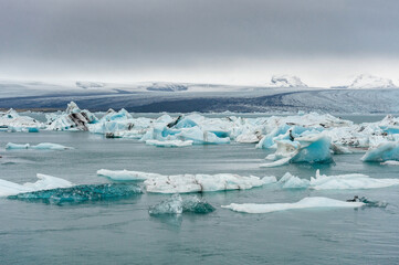 Water and Iceberg in Jokulsarlon Glacier Lagoon. Mountain in Background