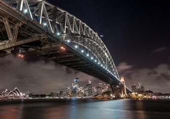 Sydney Harbour Bridge and Opera House at Night. Beautiful Sydney Cityscape and Skyline. Long Exposure. Flowing Sky. Australia