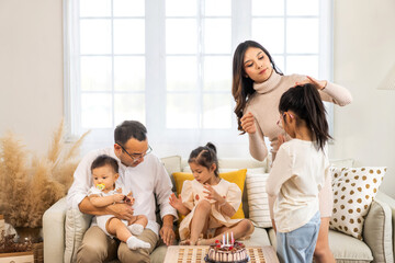 Portrait of enjoy happy love asian family father and mother holding hug cute little asian girl child and baby smiling play and having fun moments good time in at home