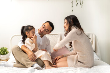 Portrait of enjoy happy love asian family father and mother holding hug cute little asian girl child smiling play and having fun moments good time in at home