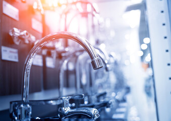 Rows of metal water taps at the showroom of a large store
