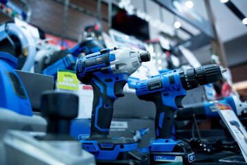 Construction carpentry electric cordless drill at the showroom of a large store.