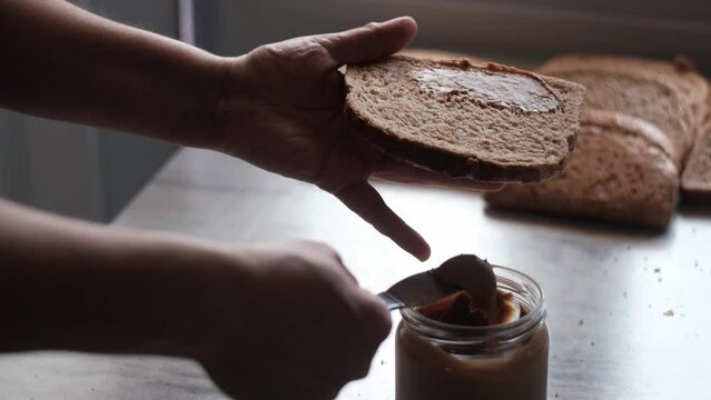 Peanut Butter and Slice of Bread in Dramatic Light, Slow Motion 4K
