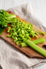 Raw Green Organic Celery on a rustic wooden board, low angle view.
